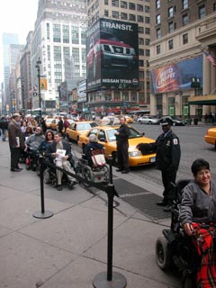larger photo of people in wheelchairs at taxi stand