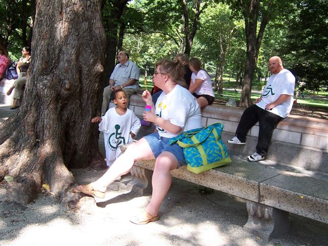 larger photo of a woman blowing bubbles to a little boy