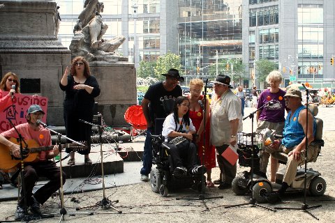 larger photo of activists singing at ADA rally