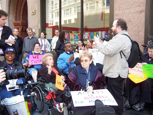 larger photo of Disabled In Action activists gathering for the press conference