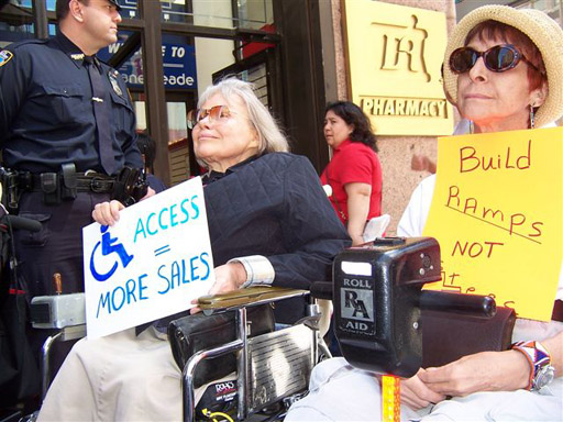 larger photo of Disabled In Action activists waiting for the start of the press conference