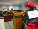 photo of closer view of Jean Ryan speaking at a podium at TLC hearing