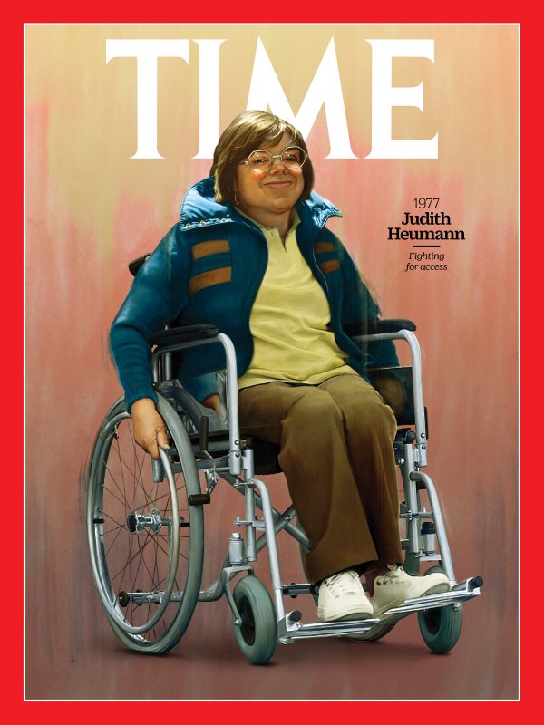 A painting of Judy Heumann on the cover of TIME Magazine. She has short brown hair, silver rimmed glasses, and is seated in her silver manual wheelchair, smiling. She is wearing a blue jacket, a yellow shirt, and brown pants with white shoes. Next to her says "1977. Judith Heumann" with "fighting for access" written in italics underneath. The background is a mix of yellow, pink, and brown with a red border.