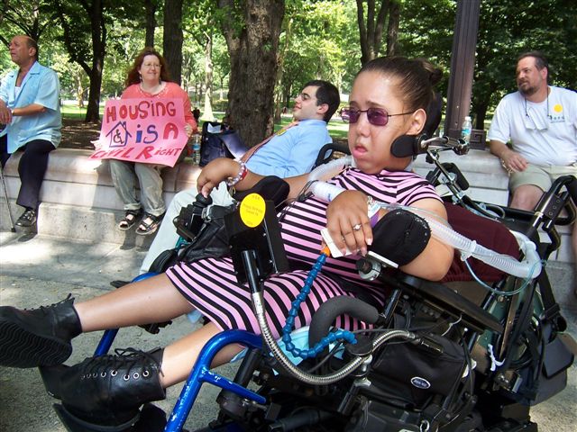 A woman in a wheelchair watching the DIA Singers performance