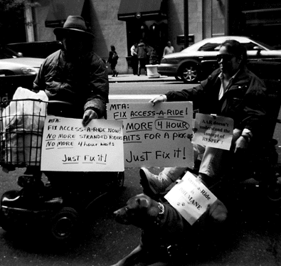 photo of demonstrators holding signs reading Just Fix It