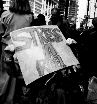 Antoinette Williams holds sign reading Stress A Ride