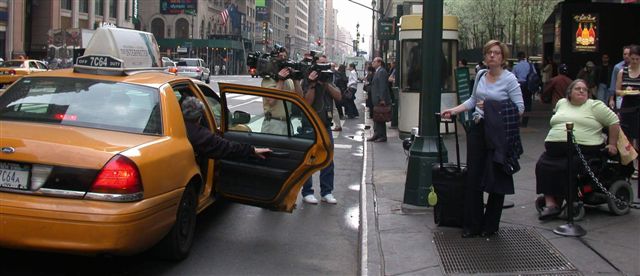 cameramen filming the taxi line in front of Penn Station