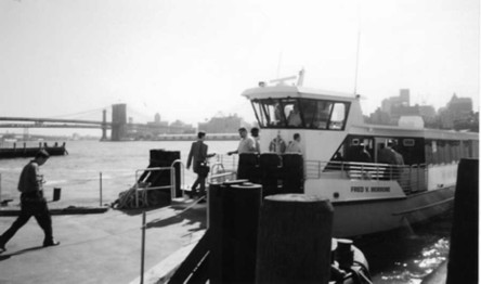 A nondisabled passenger walks up two steps into the ferry.