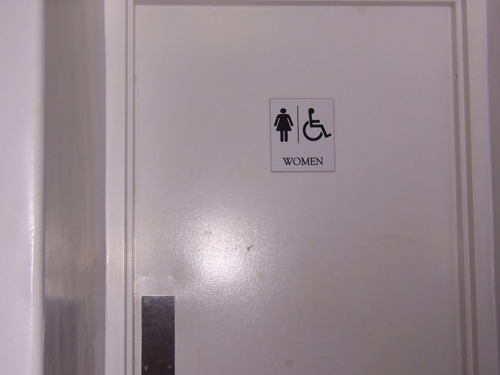 Photo of a handicap sign on the women's restroom door in New York's City Hall
