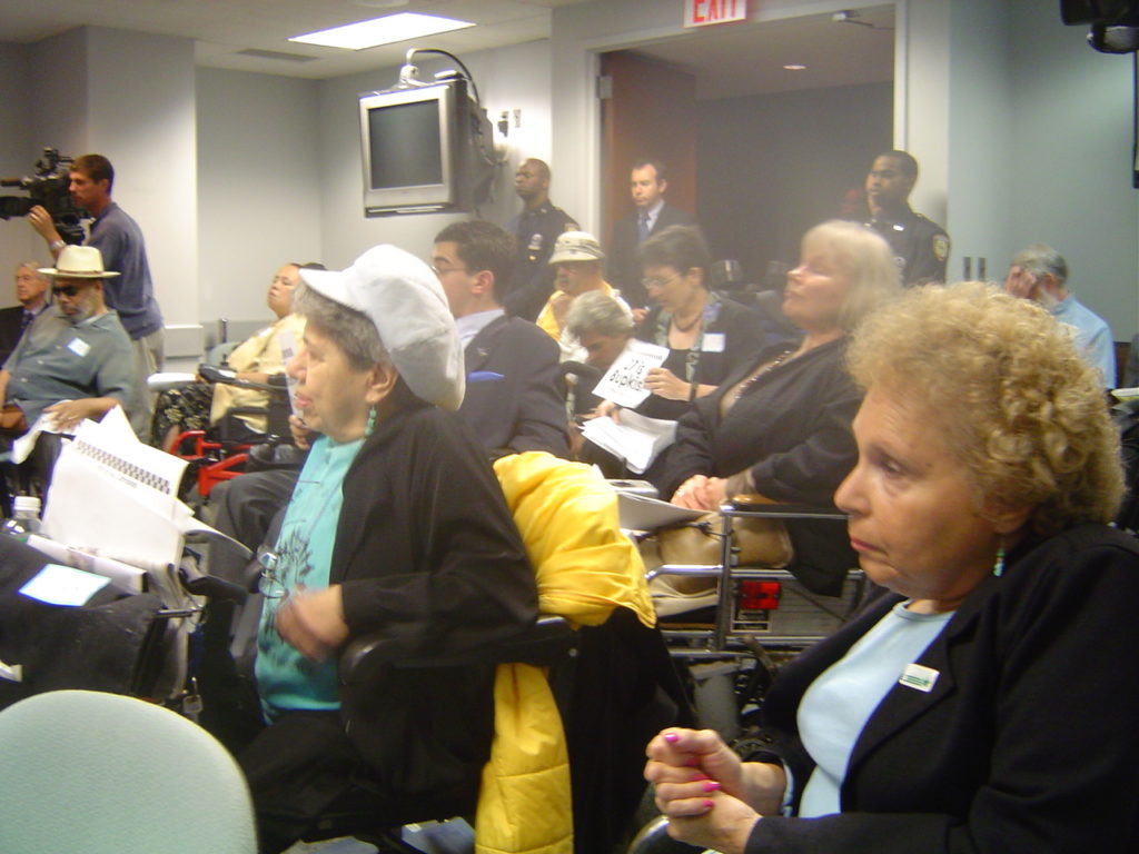 Photo of Frieda Zames, Carr Massi and others at TLC hearing in August 2004