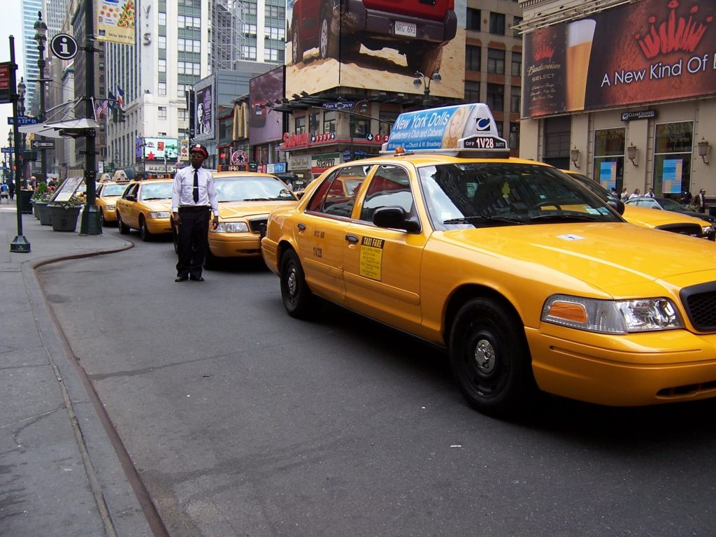 Photo of several taxi cabs lined up on Seventh Avenue in front of Penn Station